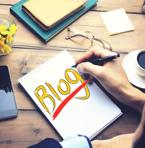 man-writing-blog-paper-wooden-working-table-min